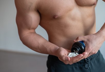 Man pouring pills into hand